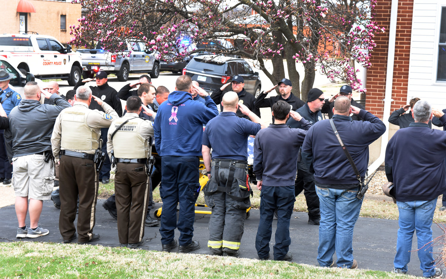 Law enforcement personnel from across the region salute Monday afternoon as the flag-draped body of Hermann Det. Sgt. Mason Griffith is brought to Gottenstroeter Funeral Home in Owensville following a 27-vehicle procession from St. Charles County following an autopsy. Area fire departments and ambulance districts also participated in the procession and lined Highway 28 in Owensville and Rosebud.